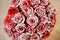Adorable red roses decorated with white glitter sand