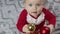 adorable santa claus baby playing with Christmas lights