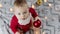 adorable santa claus baby playing with Christmas lights