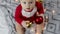 adorable santa claus baby playing with Christmas lights