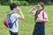 adorable schoolchildren with backpacks looking at each other