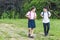 adorable schoolchildren walking by pathway