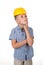 Adorable serious future builder in yellow helmet and blue checkred shirt, has a good idea, isolated on white background