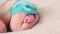 Adorable sleeping baby in blue knitted clothes