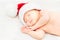 Adorable sleeping newborn baby in Santa Claus hat, Christmas