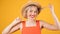 Adorable smiling blonde woman in straw hat on yellow background. Positive happy emotions. Stop motion video footage