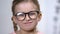 Adorable smiling girl adjusting eyeglasses, smart kid, female pupil, education