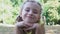 Adorable smiling girl looking camera lying park grass, summer leisure, childhood