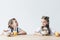 adorable smiling schoolgirls eating cereals with orange juice for breakfast