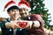 Adorable smiling young LGBT couple holding red heart and giving it to the camera, Asian gay male lover celebrating and sharing