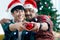 Adorable smiling young LGBT couple holding red heart and giving it to the camera, Asian gay male lover celebrating and sharing