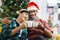 Adorable smiling young LGBT couple sharing special moment together on Christmas holiday, Asian gay male lover sitting on sofa,