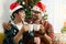 Adorable smiling young LGBT couple sharing special moment together on Christmas holiday, Asian gay male lover sitting on sofa,