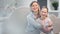 Adorable smiling young mother hugging cute daughter posing together surrounded by light glare