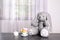 Adorable stuffed bunny and toy tableware on table, space for text. Child room elements