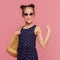 Adorable stylish girl in sunglasses waving hand