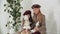 Adorable stylish girls in coats and berets posing with elegant vintage dolls