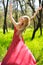 Adorable summer young woman in long red dress