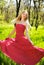 Adorable summer young woman in long red dress