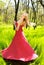 Adorable summer young woman in long red dress