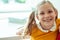 Adorable teen girl with blonde pigtails and cute smile at school with books on background