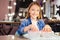 Adorable teenage girl soaking fingernails in a bowl