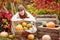 Adorable teenager girl with  pumpkins in autumn park. Autumn activities for children. Halloween and Thanksgiving time fun for