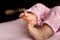 Adorable tiny feet of newborn baby girl in a selective focus