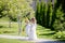 Adorable toddler boy and girl in angel costumes sitting together, boy giving red rose to the girl