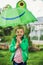 Adorable toddler boy with green frog umbrella