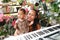 Adorable toddler boy in shirt with mom behind piano