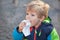 Adorable toddler eating bread outdoor