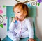 Adorable Toddler Girl Brushes Her Teeth in Pajamas. Health Care concept.