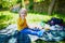 Adorable toddler girl having picnic in countryside on a summer day