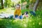 Adorable toddler girl having picnic in countryside on a summer day