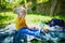 Adorable toddler girl having picnic in countryside on a summer day