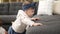 Adorable toddler leaning on sofa standing at home