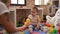 Adorable toddler playing with plastic construction blocks looking ball at kindergarten