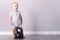 Adorable toddler in retro style sport suit going to lift a kettlebell