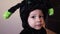 Adorable toddler with spider costume making funny face expressions