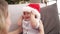 Adorable toddler wearing christmas hat smiling for tickles at home