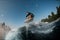adorable view of a male wakesurfer flying over the wave while jumping