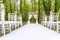 Adorable wedding archway with lined up chairs