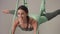 Adorable woman yoga trainer during aerial yoga master class