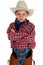 Adorable young cowboy looking at camera arms folde