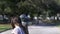 Adorable young girl cleaning the head of a child statue in a park