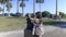 Adorable young girl cleaning the head of a child statue in a park