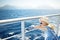 Adorable young girl enjoying ferry ride staring at the deep blue sea. Child having fun on summer family vacation in Greece