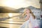 Adorable young girl enjoying ferry ride staring at the sea on sunset. Child having fun on summer family vacation in Greece