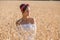 Adorable young girl on golden wheat field